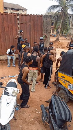 Young men gather on dusty streets in Onitsha, Nigeria