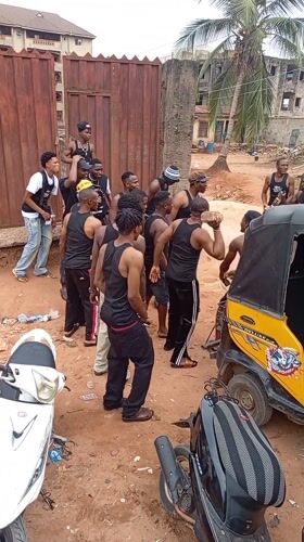 Young men gather on dusty streets in Onitsha, Nigeria