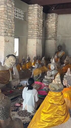 Temple visit in Baan Harn: offerings, statues, and sacred iconography