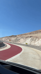 Desert road with red marking section filmed near Arica