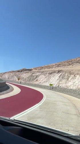 Desert road with red marking section filmed near Arica