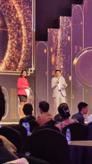 Award handoff moment on a Mumbai stage