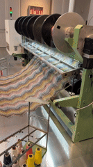 Museum visitors watch knitting machine demonstration at Fondazione Missoni