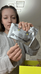 Woman unboxes Golden Apple beauty products in Russian home
