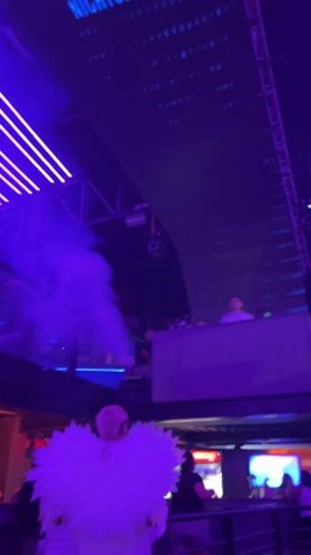 Late night club scene with costumed performer in Arica