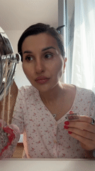 Woman applies makeup in Budva home during morning routine