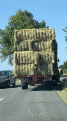 Hay transport convoy moves through rural Chambœuf streets