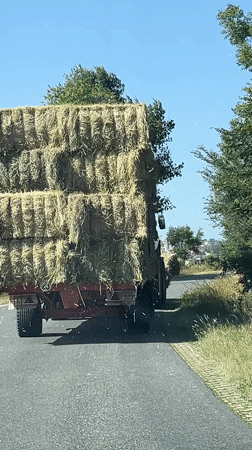 Hay transport convoy moves through rural Chambœuf streets