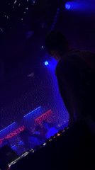 DJ performs at Moscow nightclub with dramatic lighting effects