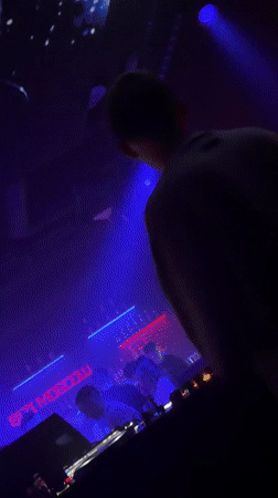 DJ performs at Moscow nightclub with dramatic lighting effects