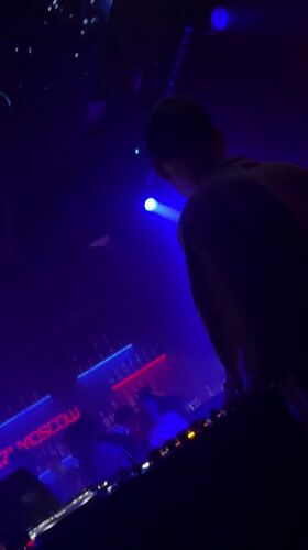 DJ performs at Moscow nightclub with dramatic lighting effects