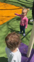 Children play at Kiryat Bialik playground with cat
