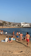 Busy afternoon on Arona's palm-lined beach promenade