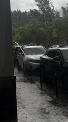 Heavy rainfall floods Tbilisi streets, water cascades onto parked cars