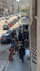 Drumming procession in African-style clothing moves through Milan streets