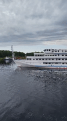 Passenger ship Princess Anastasia sails Russian waterway at dawn