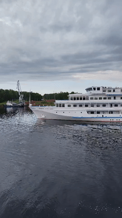Passenger ship Princess Anastasia sails Russian waterway at dawn