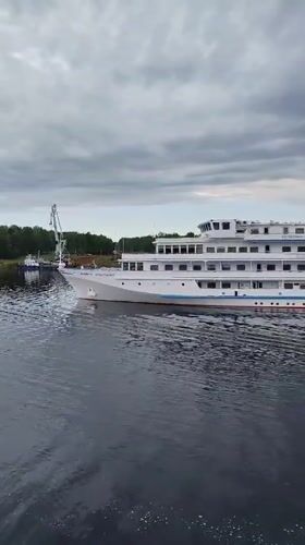 Passenger ship Princess Anastasia sails Russian waterway at dawn