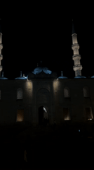 Istanbul mosque glows peacefully at night as people stroll