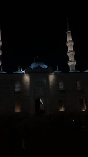 Istanbul mosque glows peacefully at night as people stroll