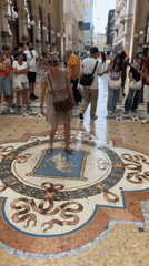 Spinning on the bull mosaic at Milan's Galleria