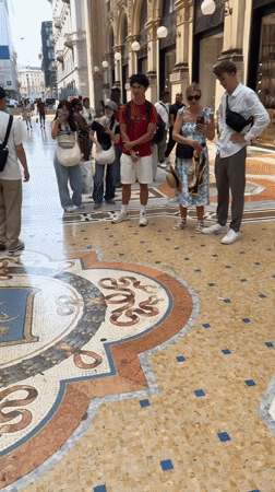 Spinning on the bull mosaic at Milan's Galleria