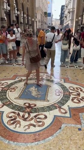 Spinning on the bull mosaic at Milan's Galleria