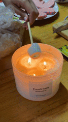 Woman toasts marshmallow over candle in Tashkent