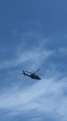 Beach day captured in Serik, Turkey with sunbather, helicopter