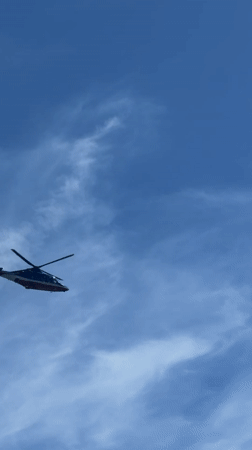 Beach day captured in Serik, Turkey with sunbather, helicopter