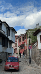 Tourists document historic Plovdiv Old Town cobblestone streets