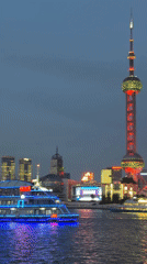 Tourists photograph Shanghai skyline from Bund waterfront Sunday morning