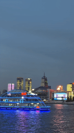 Tourists photograph Shanghai skyline from Bund waterfront Sunday morning