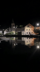 Nighttime waterfront village scene captured in Tivat, Montenegro