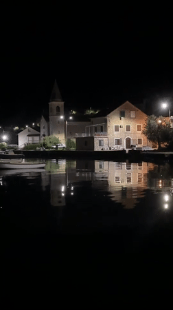 Nighttime waterfront village scene captured in Tivat, Montenegro