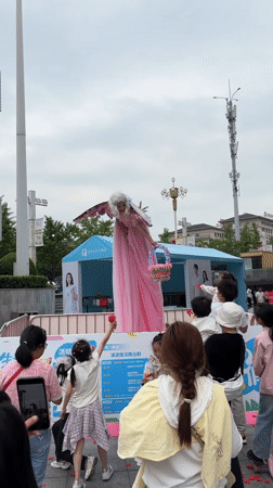 Stilt fairy performer entertains children at Jiangjin plaza event