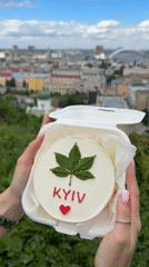 Person holds decorated 'KYIV' cake in Ukraine capital