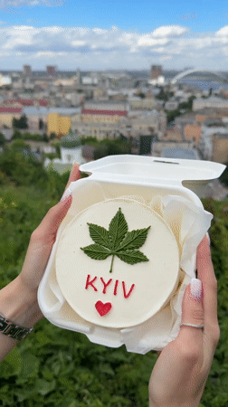 Person holds decorated 'KYIV' cake in Ukraine capital
