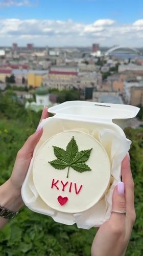 Person holds decorated 'KYIV' cake in Ukraine capital
