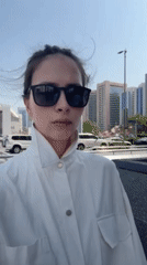 Tourist photographs Abu Dhabi skyline and mosque architecture