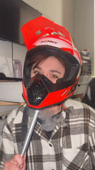 Person in KENNY motocross helmet spotted wearing plaid shirt