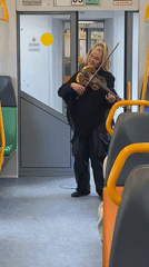 Violinist performs aboard Moscow train during morning commute