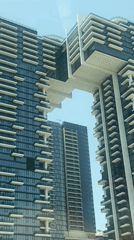 Modern Dubai skyscrapers filmed against clear blue sky