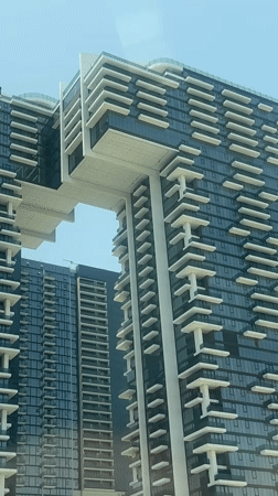 Modern Dubai skyscrapers filmed against clear blue sky