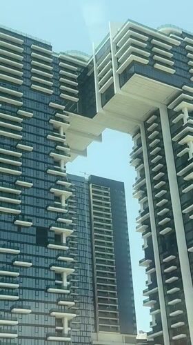 Modern Dubai skyscrapers filmed against clear blue sky