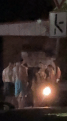 Late-night swimwear hangout outside a Lovech storefront