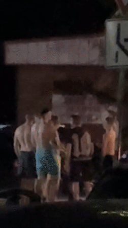 Late-night swimwear hangout outside a Lovech storefront