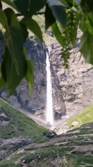 Tall waterfall cascading down rocky cliffs in Sissu, India