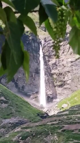 Tall waterfall cascading down rocky cliffs in Sissu, India