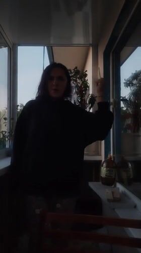 Young woman's evening activities captured on Yekaterinburg balcony
